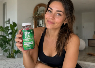 woman holding ashwagandha gummies for stress