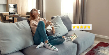 Woman smoking while reading reviews on a laptop