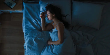 Person sleeping peacefully in bed on THC Gummies