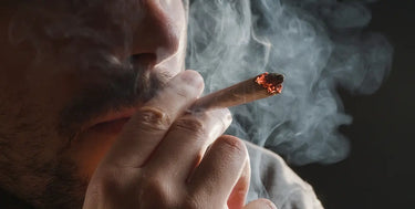 Close up of person smoking a THCA Pre-roll