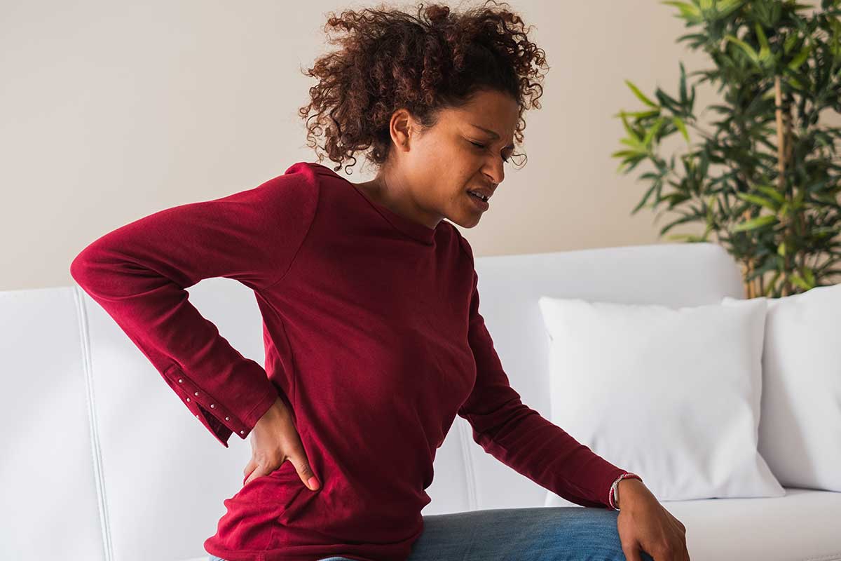 a woman experiencing back pain
