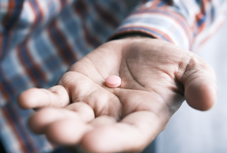 an opioid pill in an open hand