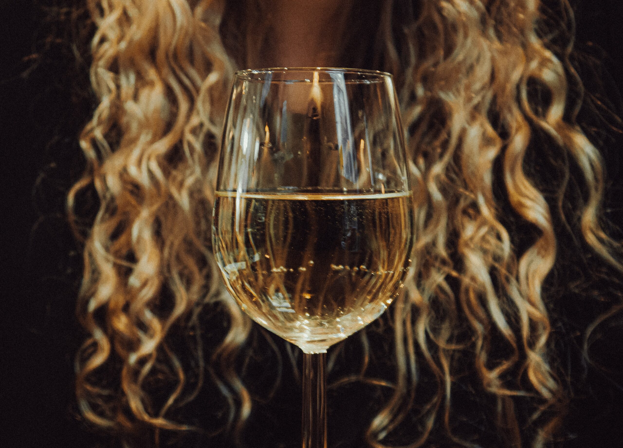 a woman drinking a glass of wine