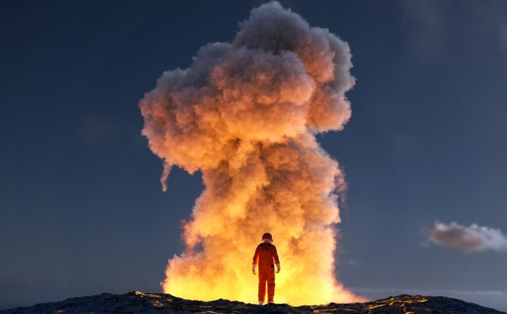 Astronaut standing in front of mushroom cloud produced by large explosion