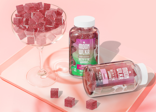 Bottles of Delta-9 Gummies in flavors Sangria and Raspberry Kiwi displayed on a bar tray with cocktail glass full of gummies
