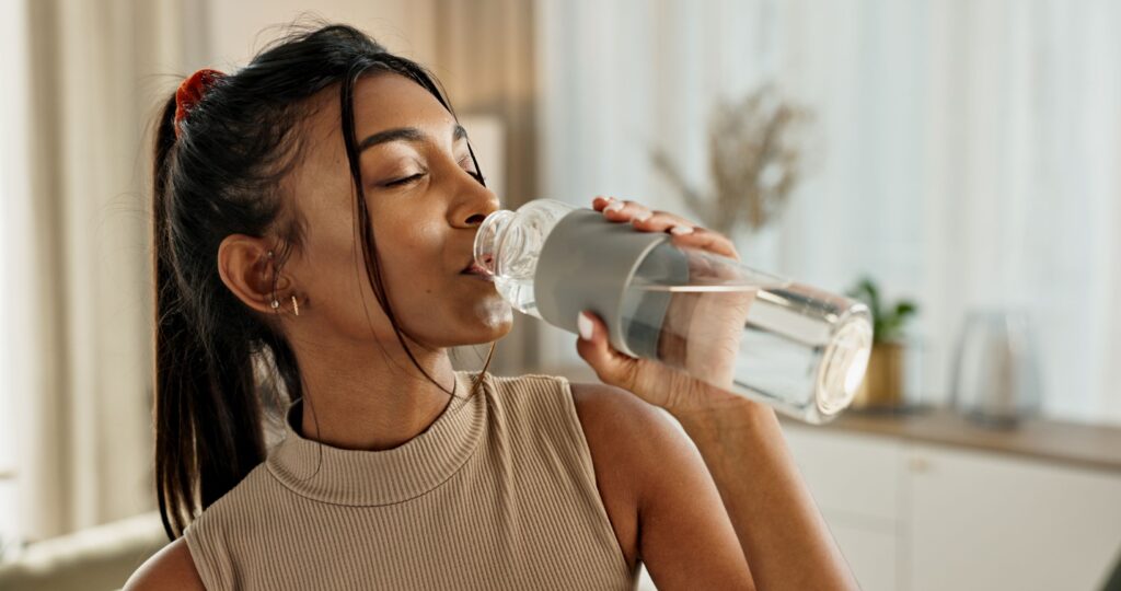 Woman drinking bottle of water