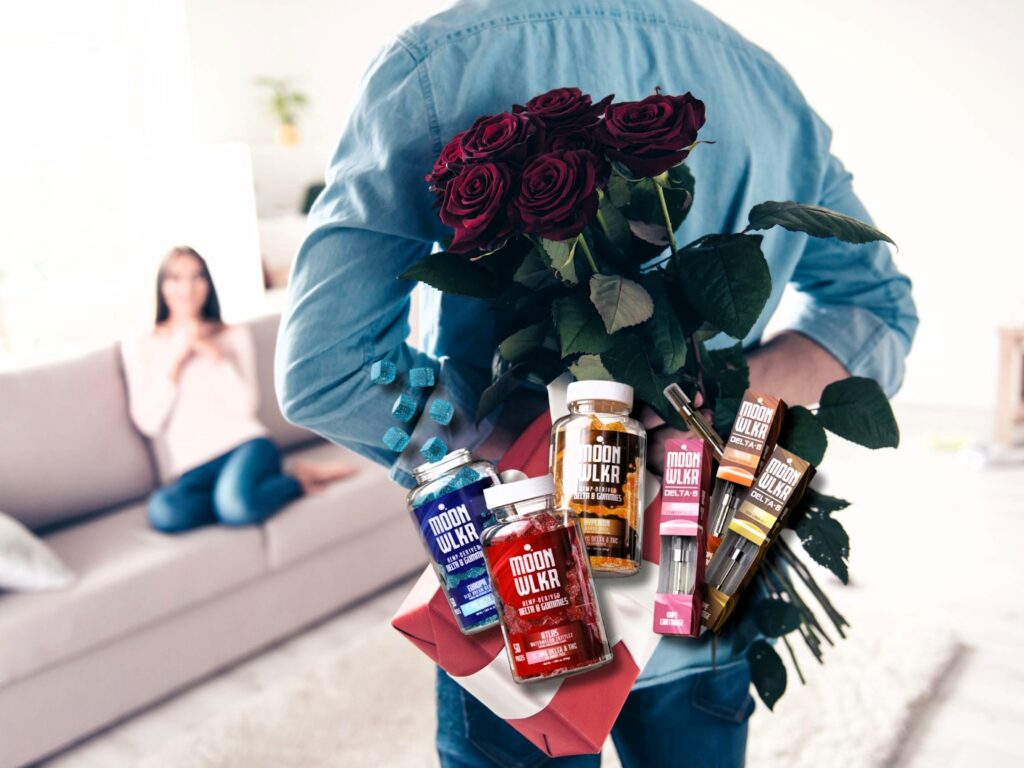 Man holding a Valentine's Day surprise gift of roses and Moonwlkr products behind his back to surprise woman sitting on couch