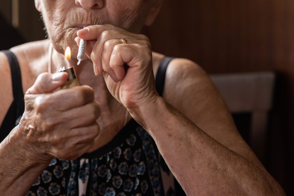 Woman holding a joint and sparking a lighter